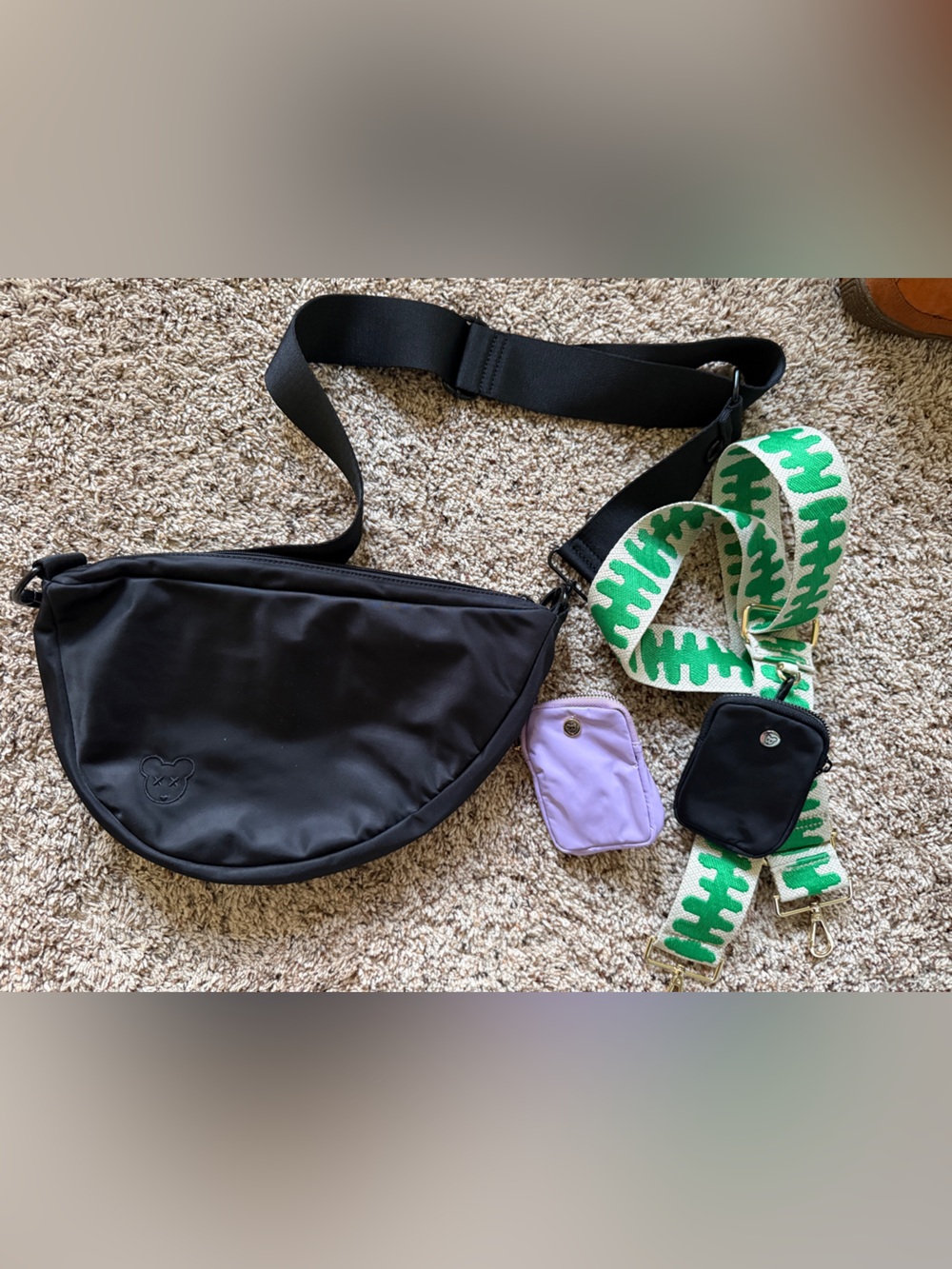 Black Crescent Crossbody Bag with Green Striped Strap